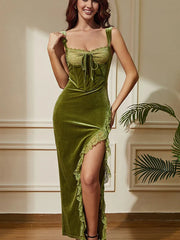 Green velvet mermaid dress with lace-trimmed corset bodice, front tie, wide straps, and lace-edged slit; model indoors.