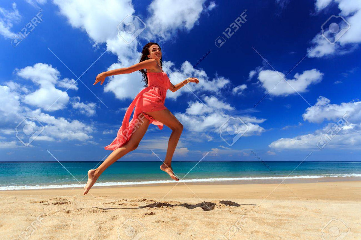 Happy Girl In Red Dress Jumping And Running On Beach Stock Photo, Picture and Royalty Free Image. Image 52046230