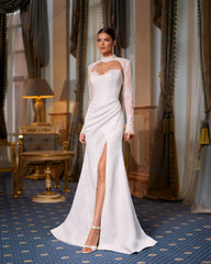 Bride in fitted lace wedding dress with sweetheart neckline, removable long-sleeve lace bolero, thigh-high slit, and chapel train.