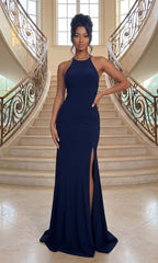A woman wearing the Long Navy Blue Prom Dress: Dear Moon J335902 with a thigh-high slit stands on marble stairs, framed by ornate railings and large windows.